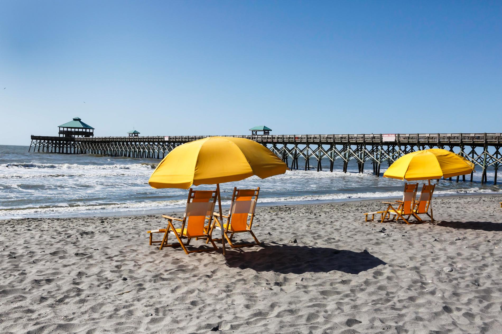 the beachfront with yellow umbrellas